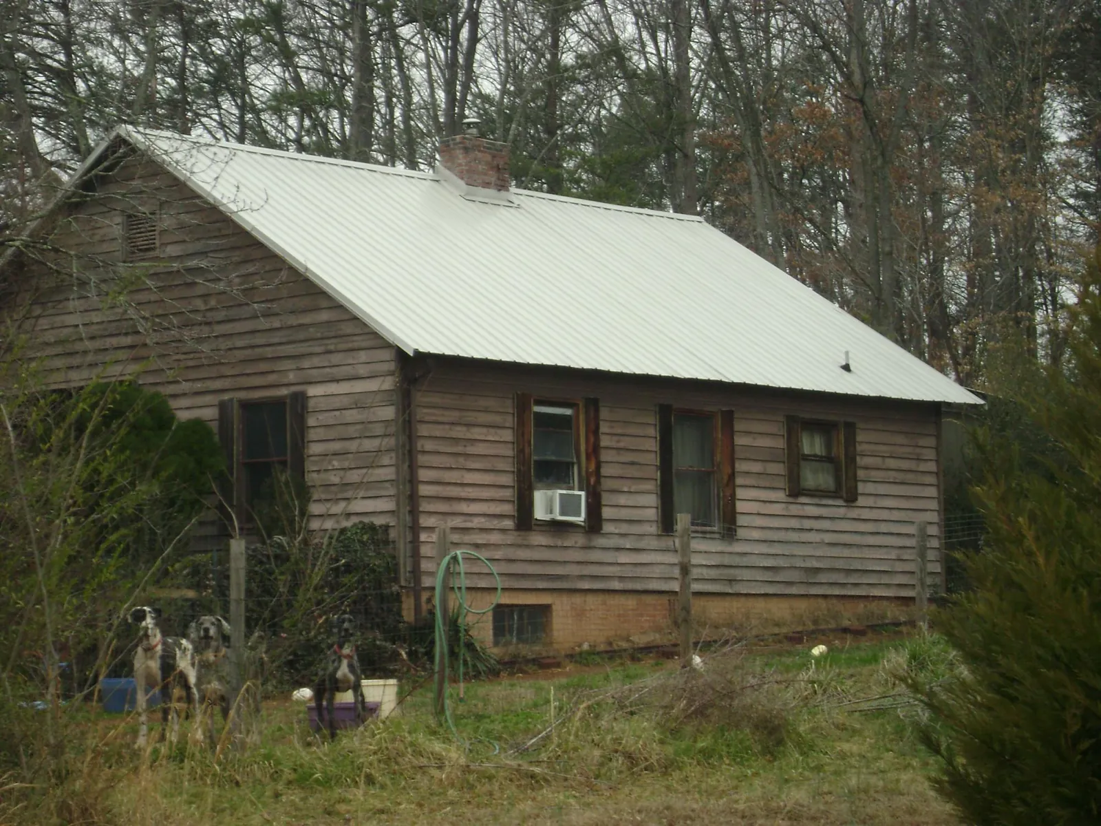 White metal roof on an old wood sided farmhouse, from a Metal Roof Installation job in Dupont