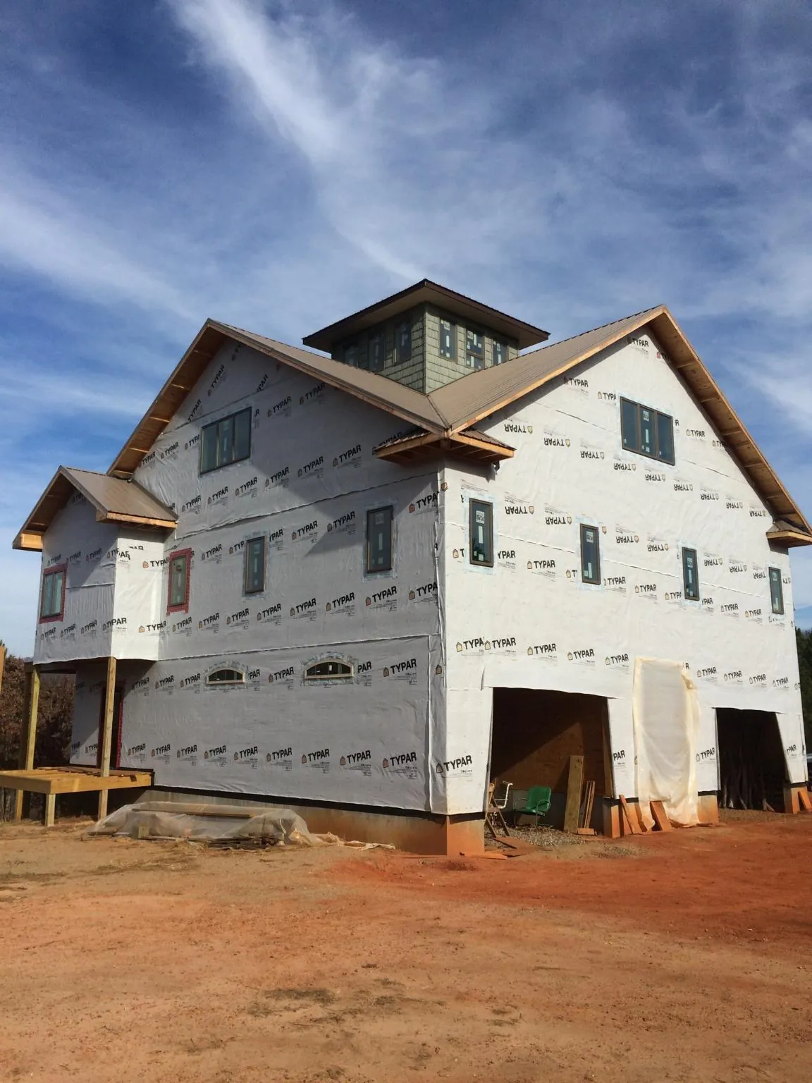 New two story house under construction with a cupola and gabled roofs in Dupont